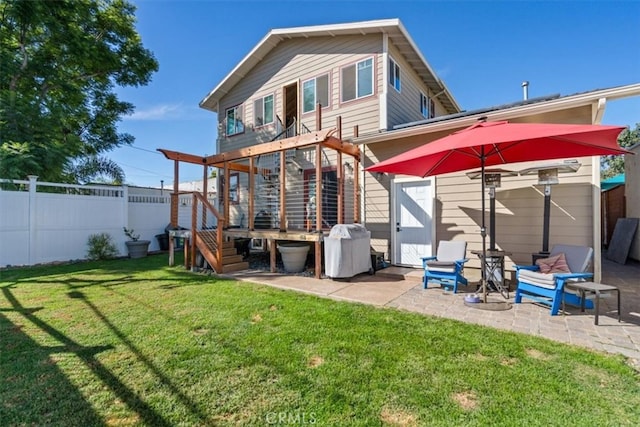 back of house with a patio area and a yard