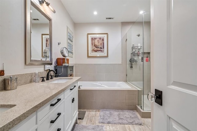 bathroom featuring wood-type flooring, vanity, and independent shower and bath