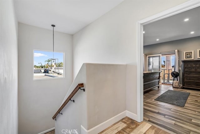 stairway with hardwood / wood-style floors