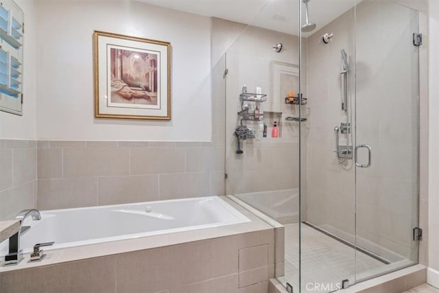 bathroom featuring separate shower and tub