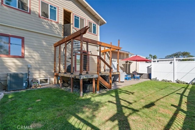 rear view of house featuring a patio area, a deck, central AC unit, and a lawn