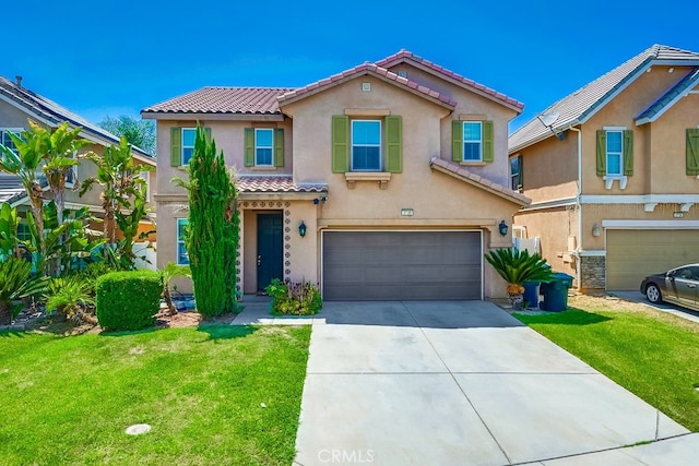 mediterranean / spanish-style house with a front lawn and a garage