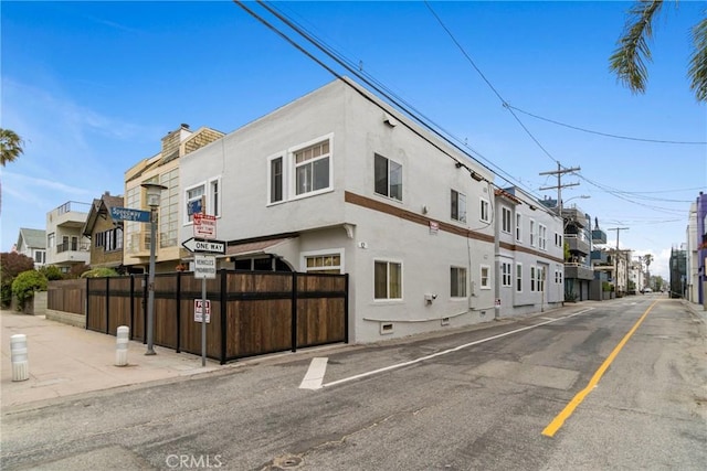 view of property featuring a residential view and fence