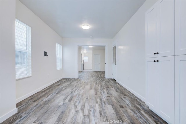 interior space featuring baseboards and wood finished floors