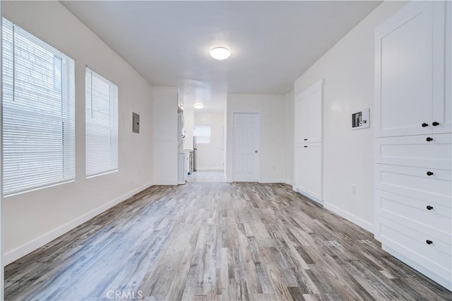 empty room with light hardwood / wood-style flooring