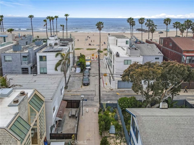 drone / aerial view featuring a water view and a beach view