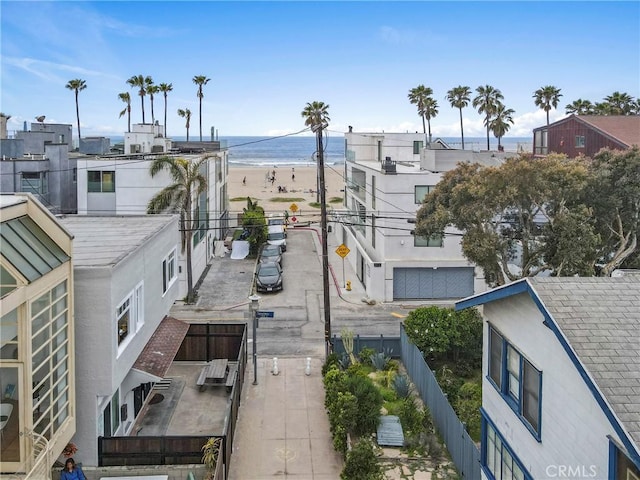 property view of water with a beach view and fence