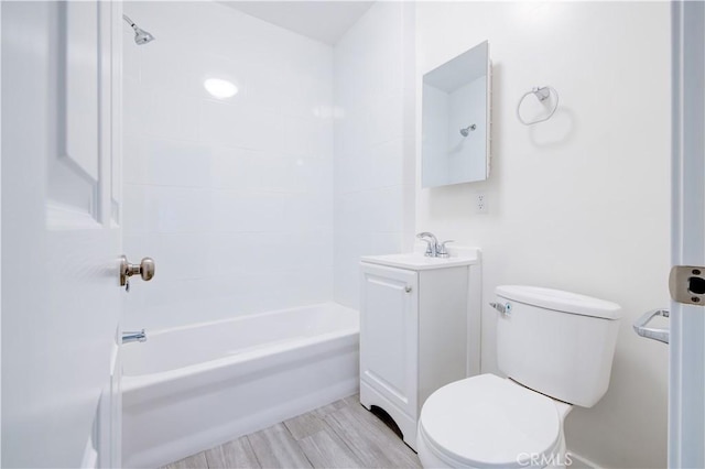 full bathroom with shower / washtub combination, toilet, vanity, and wood finished floors