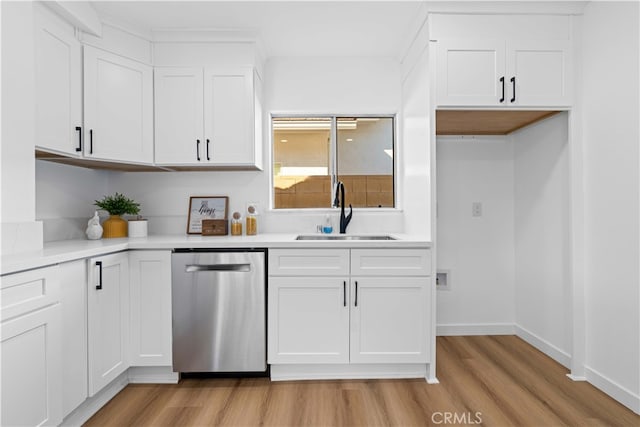 kitchen with white cabinets, light hardwood / wood-style flooring, stainless steel dishwasher, and sink