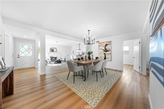 dining area featuring light hardwood / wood-style floors and an inviting chandelier