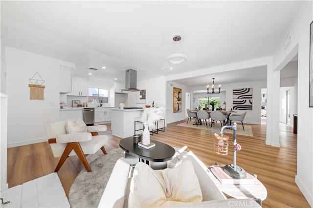 living room with a healthy amount of sunlight and light hardwood / wood-style floors