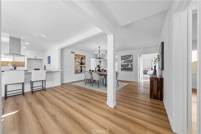 interior space featuring a chandelier and light hardwood / wood-style floors