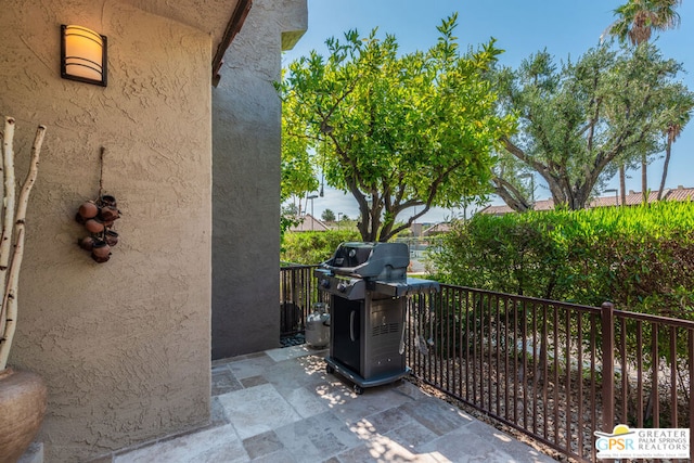 view of patio / terrace featuring a grill and a balcony