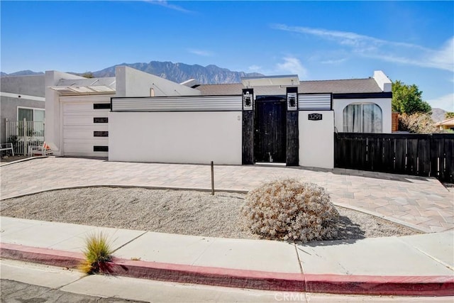 view of front of house with a garage and a mountain view