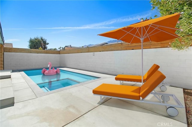 view of pool featuring an in ground hot tub and a patio area