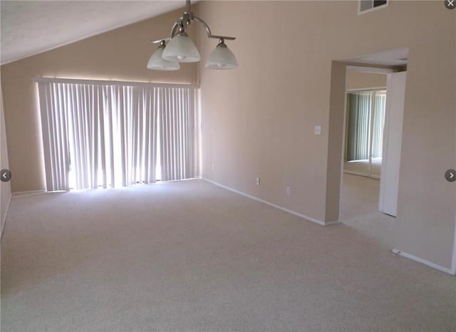 carpeted empty room featuring vaulted ceiling