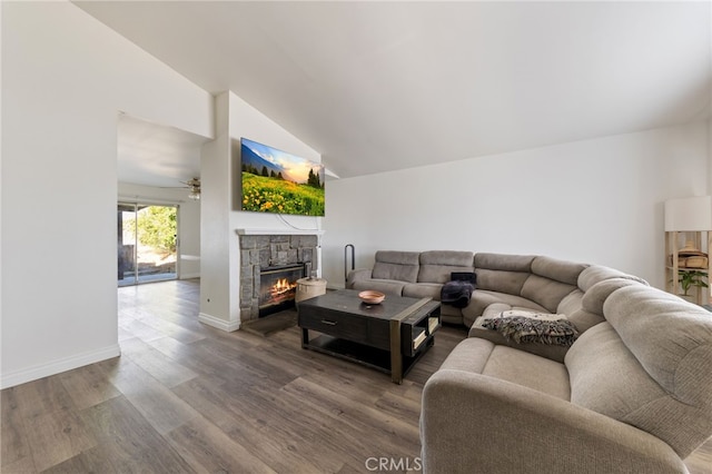 living room with hardwood / wood-style floors, high vaulted ceiling, a fireplace, and ceiling fan