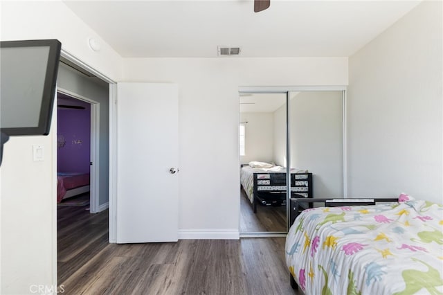 bedroom featuring dark hardwood / wood-style floors, a closet, and ceiling fan