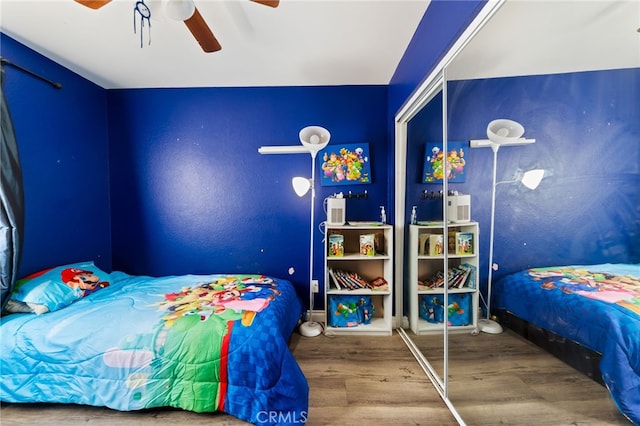 bedroom with ceiling fan and wood-type flooring