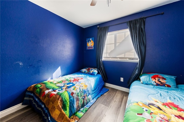 bedroom with hardwood / wood-style flooring and ceiling fan