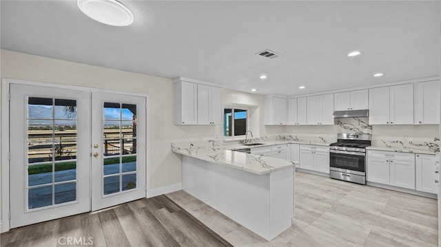 kitchen with sink, french doors, stainless steel range oven, light hardwood / wood-style floors, and white cabinets