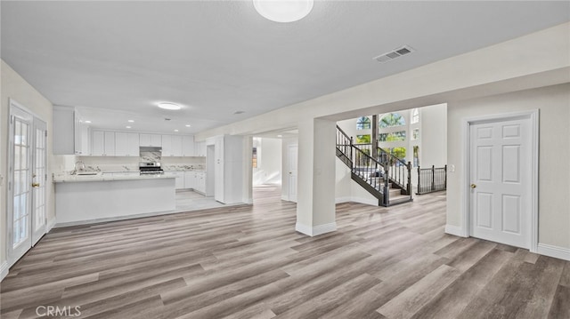 unfurnished living room with light wood-type flooring