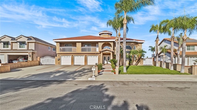 view of front of property with a balcony, a front lawn, and a garage