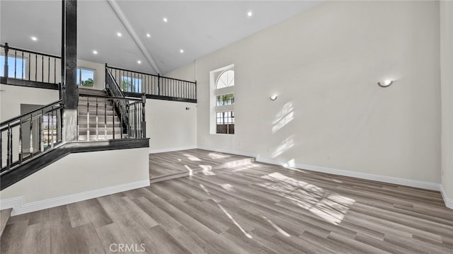 interior space featuring a wealth of natural light, light hardwood / wood-style flooring, and high vaulted ceiling