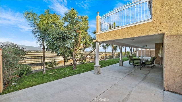 view of patio / terrace featuring a mountain view and ceiling fan