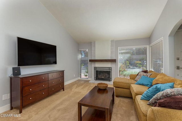 living room featuring light carpet, high vaulted ceiling, and a brick fireplace