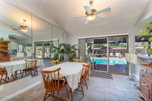 dining room featuring plenty of natural light, ceiling fan, light tile patterned floors, and vaulted ceiling