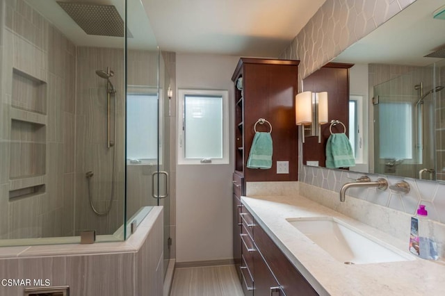 bathroom featuring vanity and an enclosed shower