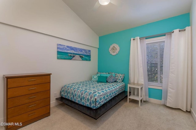 bedroom with ceiling fan, light carpet, and vaulted ceiling