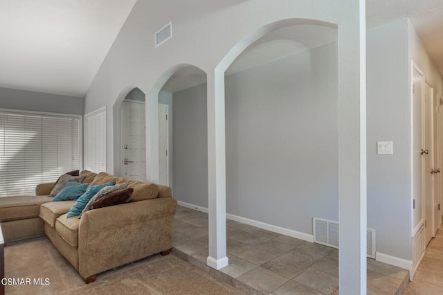 living room featuring light tile patterned flooring and lofted ceiling