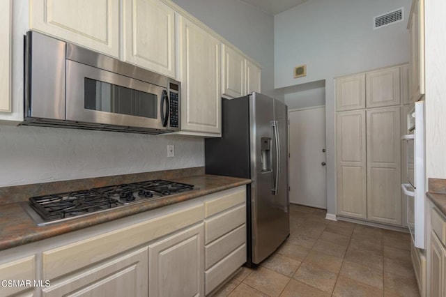 kitchen featuring light tile patterned floors and appliances with stainless steel finishes