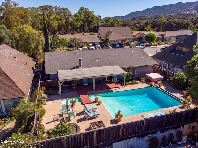 view of pool with a mountain view and a patio