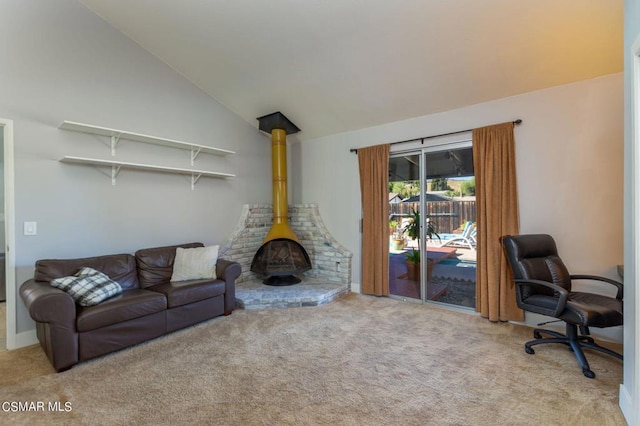 carpeted living room with a wood stove and high vaulted ceiling