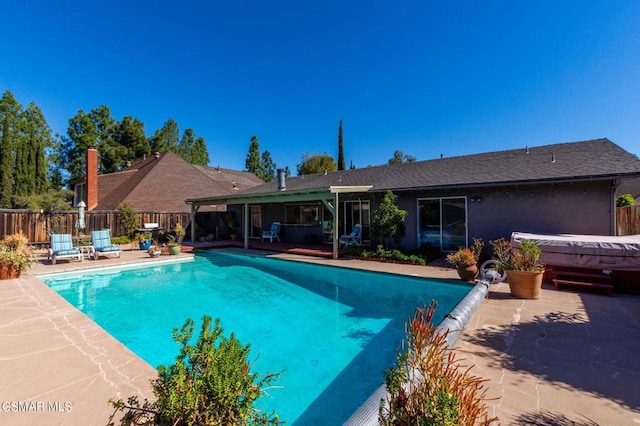 view of pool with a jacuzzi and a patio