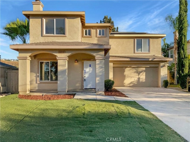 view of front of property featuring a garage and a front lawn