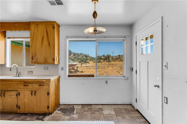 kitchen featuring sink and decorative light fixtures