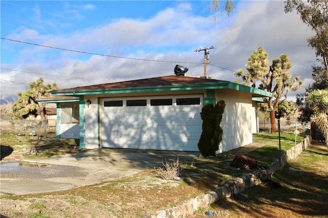 view of side of property featuring an outbuilding and a garage