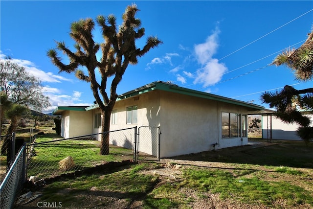 view of side of home with a yard