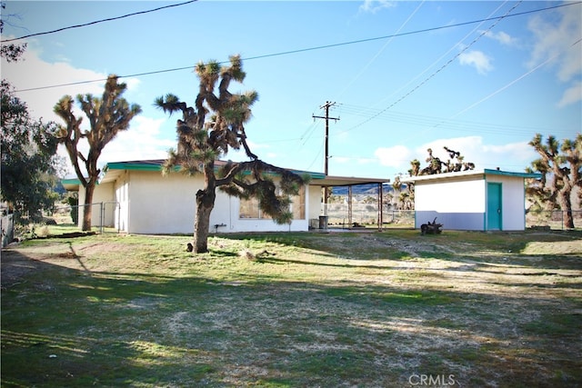 exterior space with a lawn and a carport