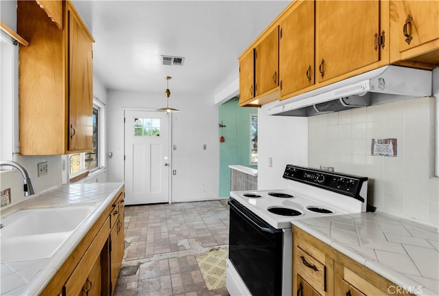 kitchen featuring sink, white range with electric cooktop, tile counters, and backsplash