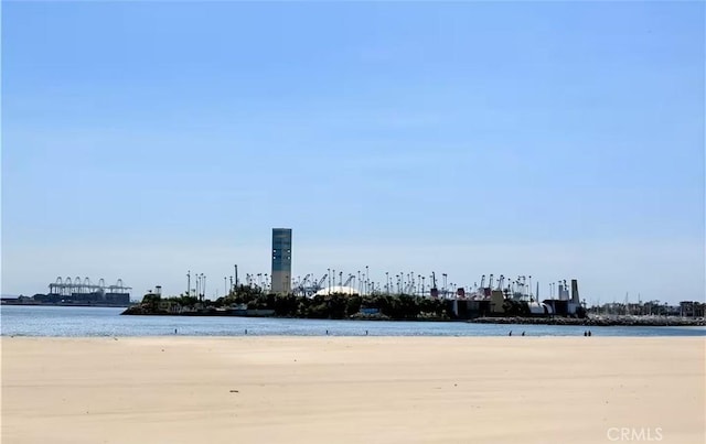 surrounding community featuring a water view and a view of the beach