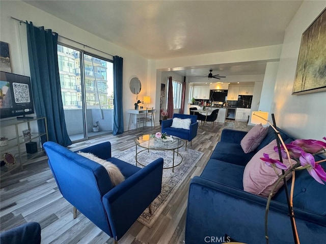 living room featuring hardwood / wood-style floors and ceiling fan