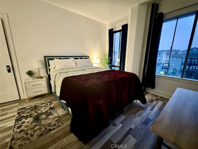 bedroom with dark hardwood / wood-style flooring