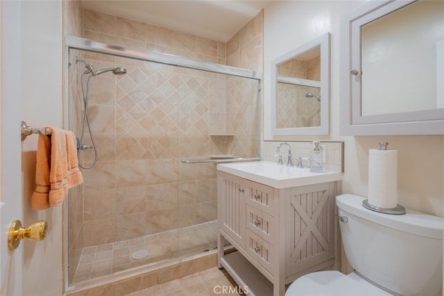 bathroom with vanity, backsplash, tile patterned flooring, toilet, and a shower with shower door