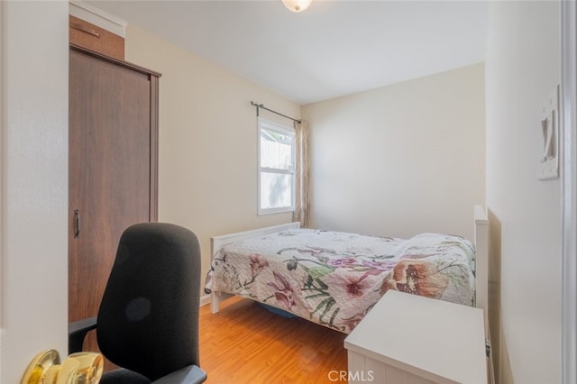 bedroom with hardwood / wood-style flooring