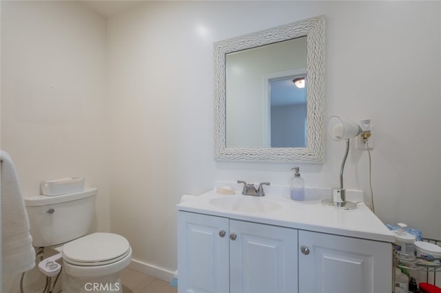 bathroom featuring tile patterned flooring, vanity, and toilet